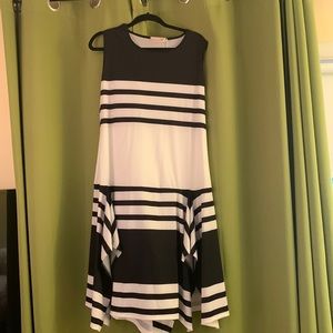 Lovely light weight black and white stripped dress  hem has an asymmetrical flow